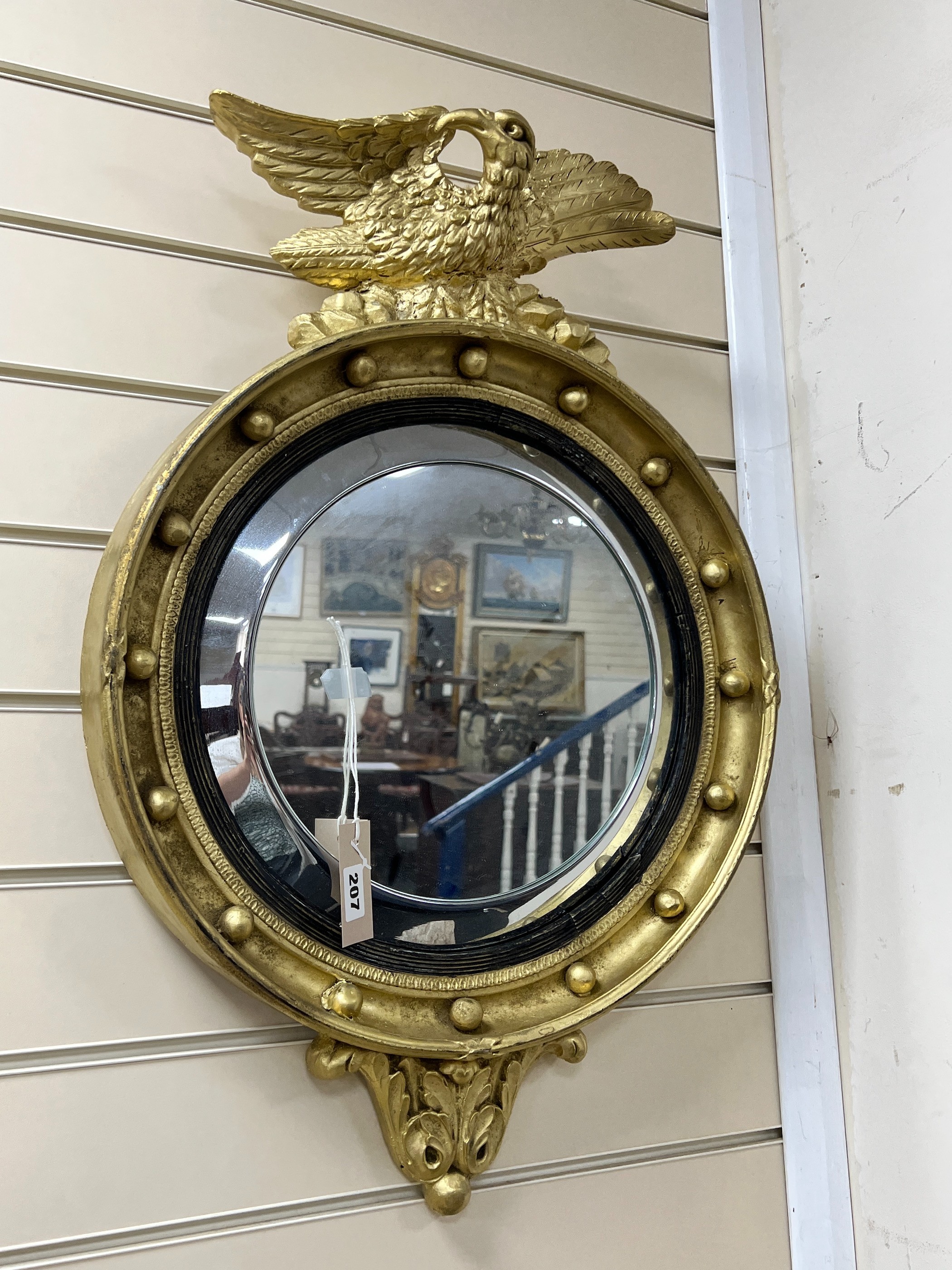 A 19th century Regency style circular wall mirror with eagle surmount, width 46cm, height 70cm